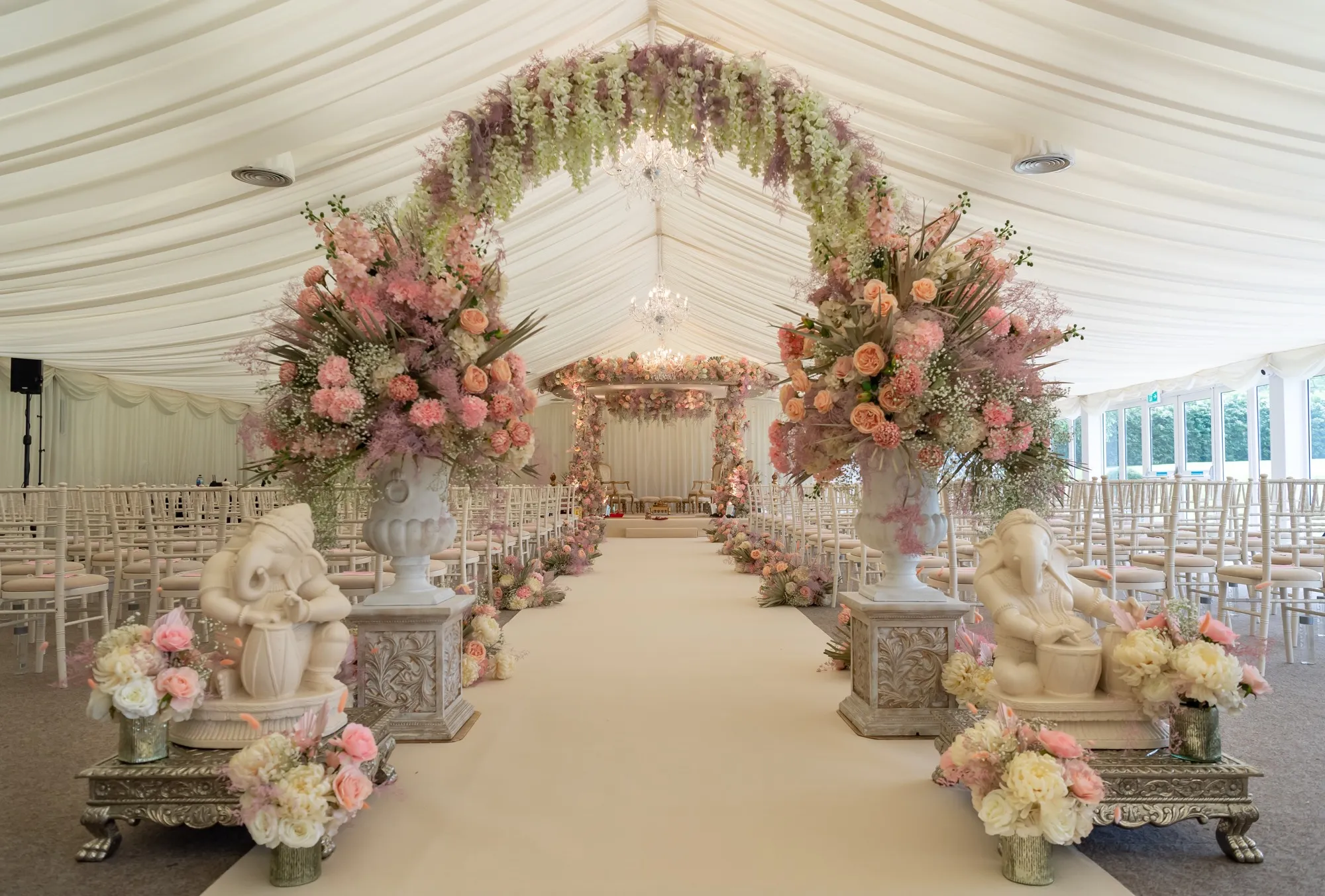 Grand and luxurious floral mandap, exquisitely set up in the pavilion, awaits a Hindu ceremony in the enchanting surroundings of North Mymms Park