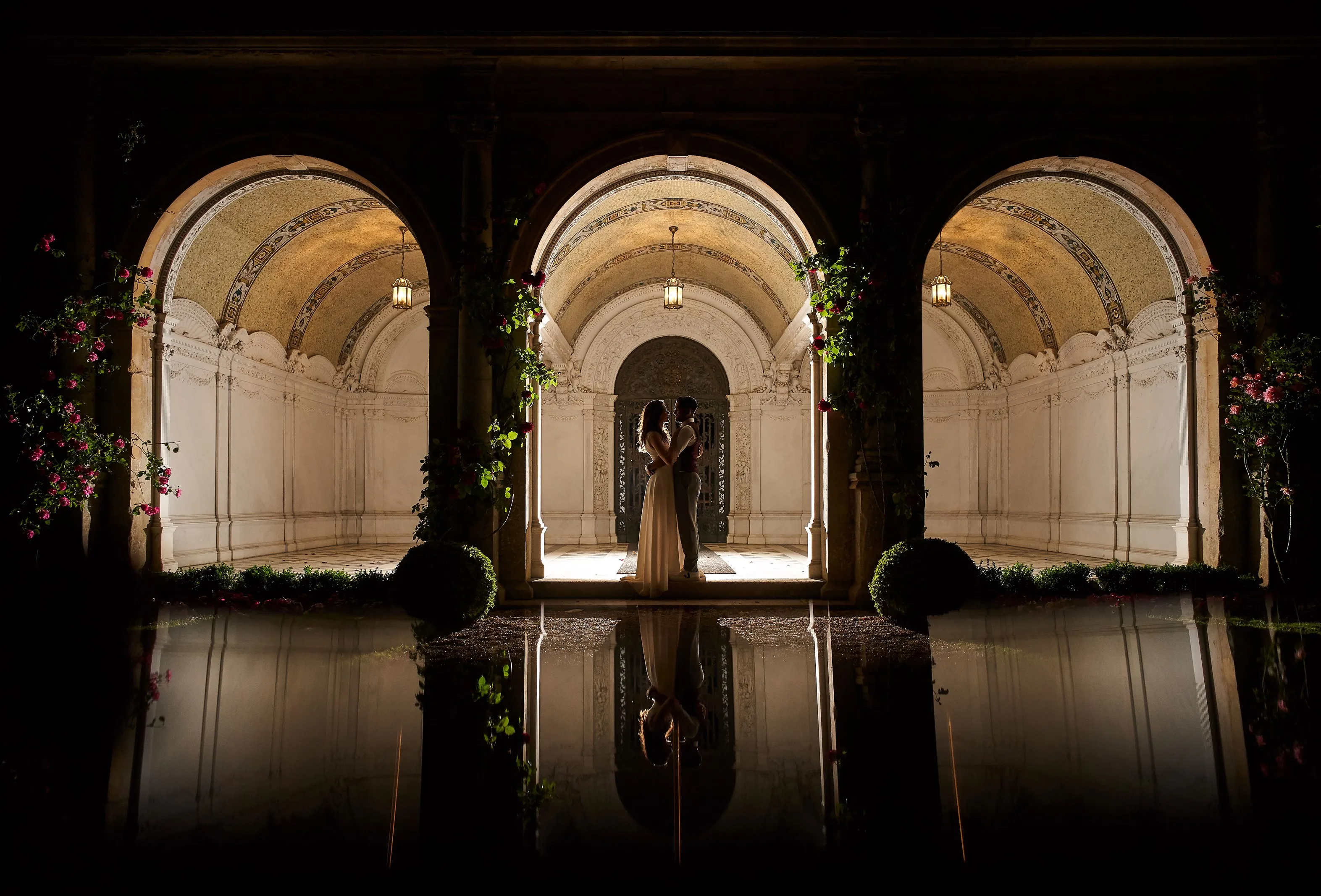 Romantic outdoor civil ceremony on a summer day at North Mymms Park's flower-filled Loggia, adorned with three marble arches