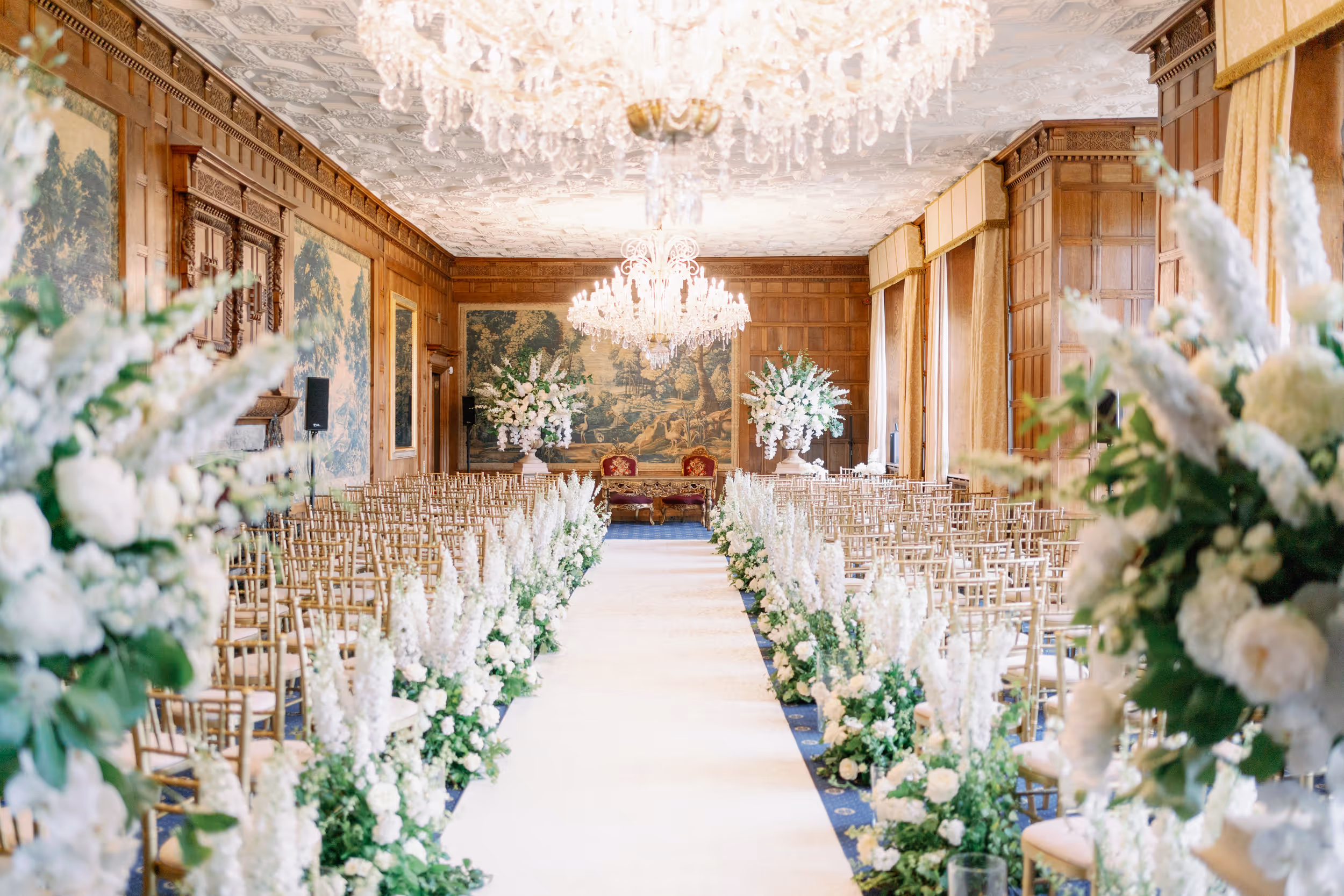 Stunning civil ceremony setup in the grand Lang Gallery at North Mymms Park, featuring Elizabethan interiors and two breathtaking chandeliers.