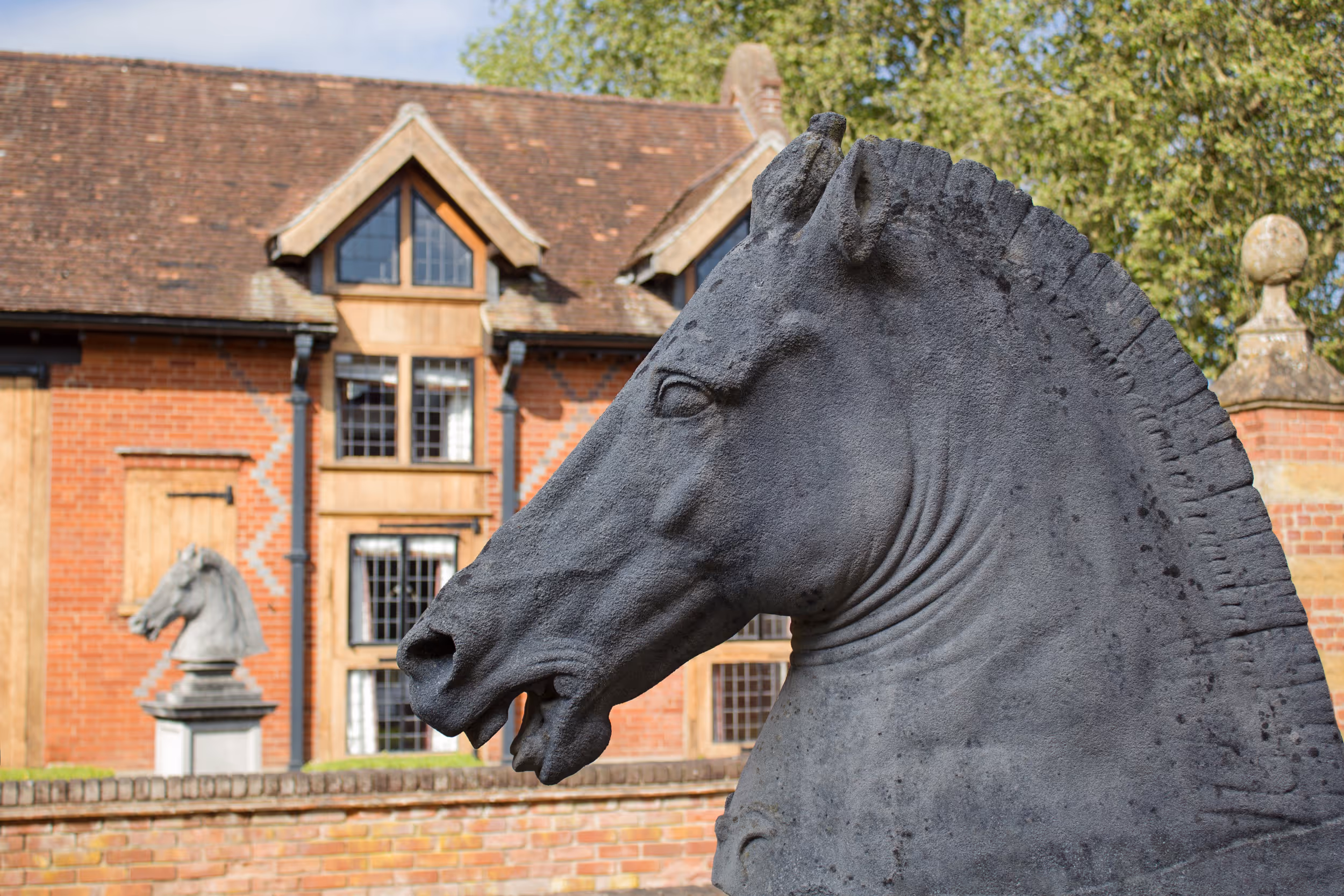 A striking horse head statue displayed in the stables at North Mymms Park, now transformed into luxurious guest accommodation.
