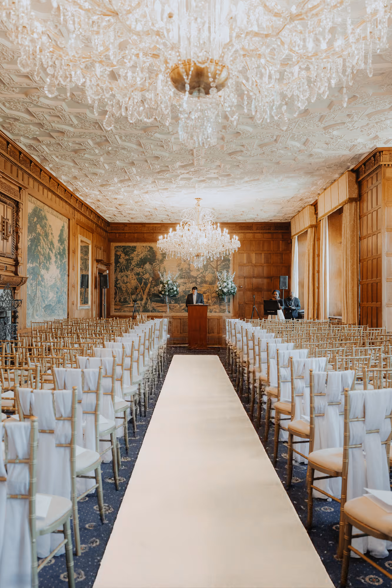 Civil ceremony setup in the stunning Lang Gallery at North Mymms Park, featuring elegant décor and breathtaking chandeliers 
