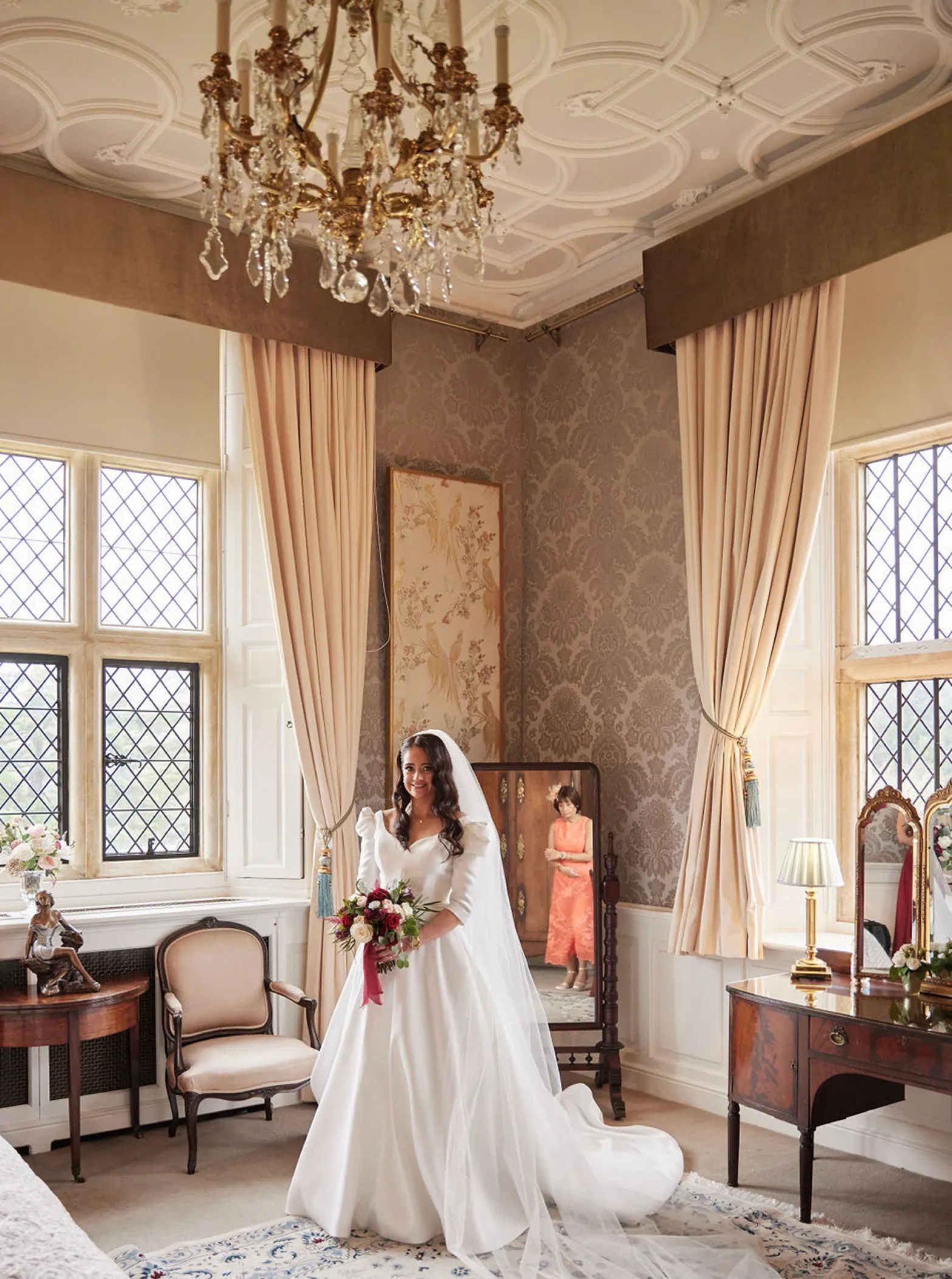 Elegantly luxurious bridal suite in a historic mansion house, adorned with ample natural light