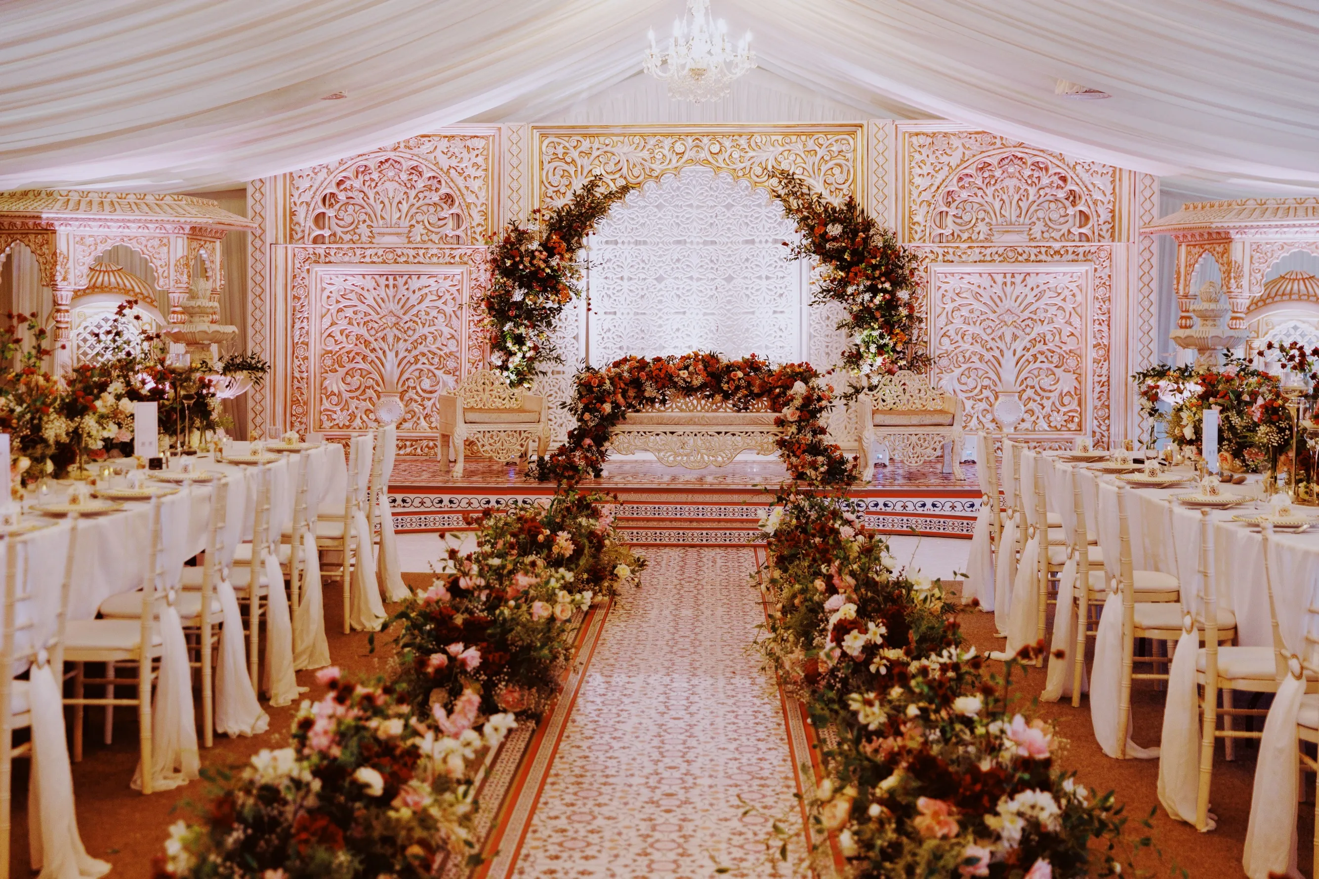 Stunning stage decor for a Nikkah ceremony, featuring elegant floral arrangements and traditional elements, in the modern and spacious Pavilion of North Mymms Park.