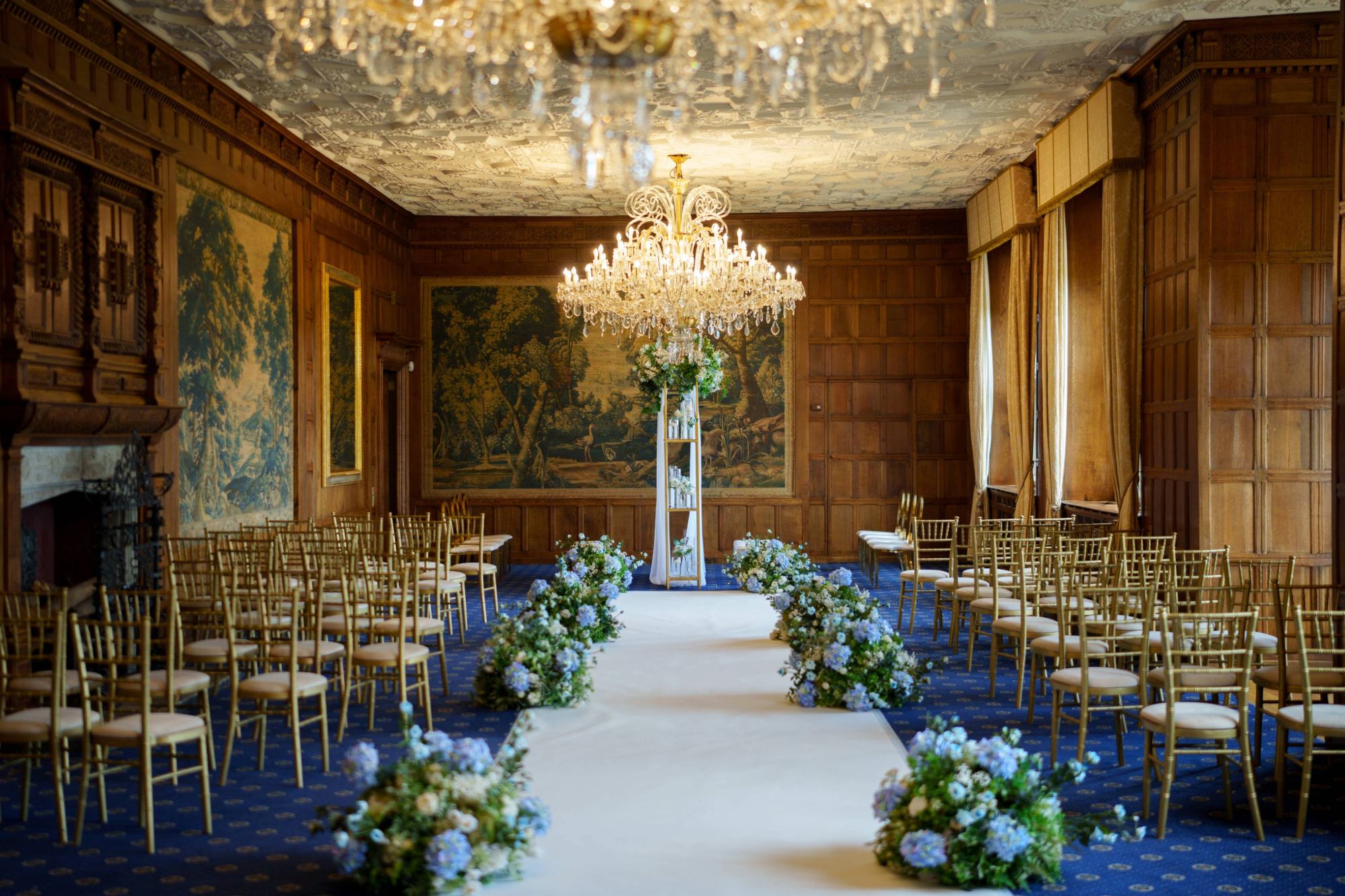 A beautiful couple sharing a tender kiss under the majestic 400-year-old Cedar Tree in the east lawn of North Mymms Park. The grand tree's branches reach high above, creating a romantic and intimate setting for the couple's special moment. The natural beauty of the surroundings, combined with the couple's affectionate embrace, makes for a truly enchanting and timeless scene at this historic and picturesque location