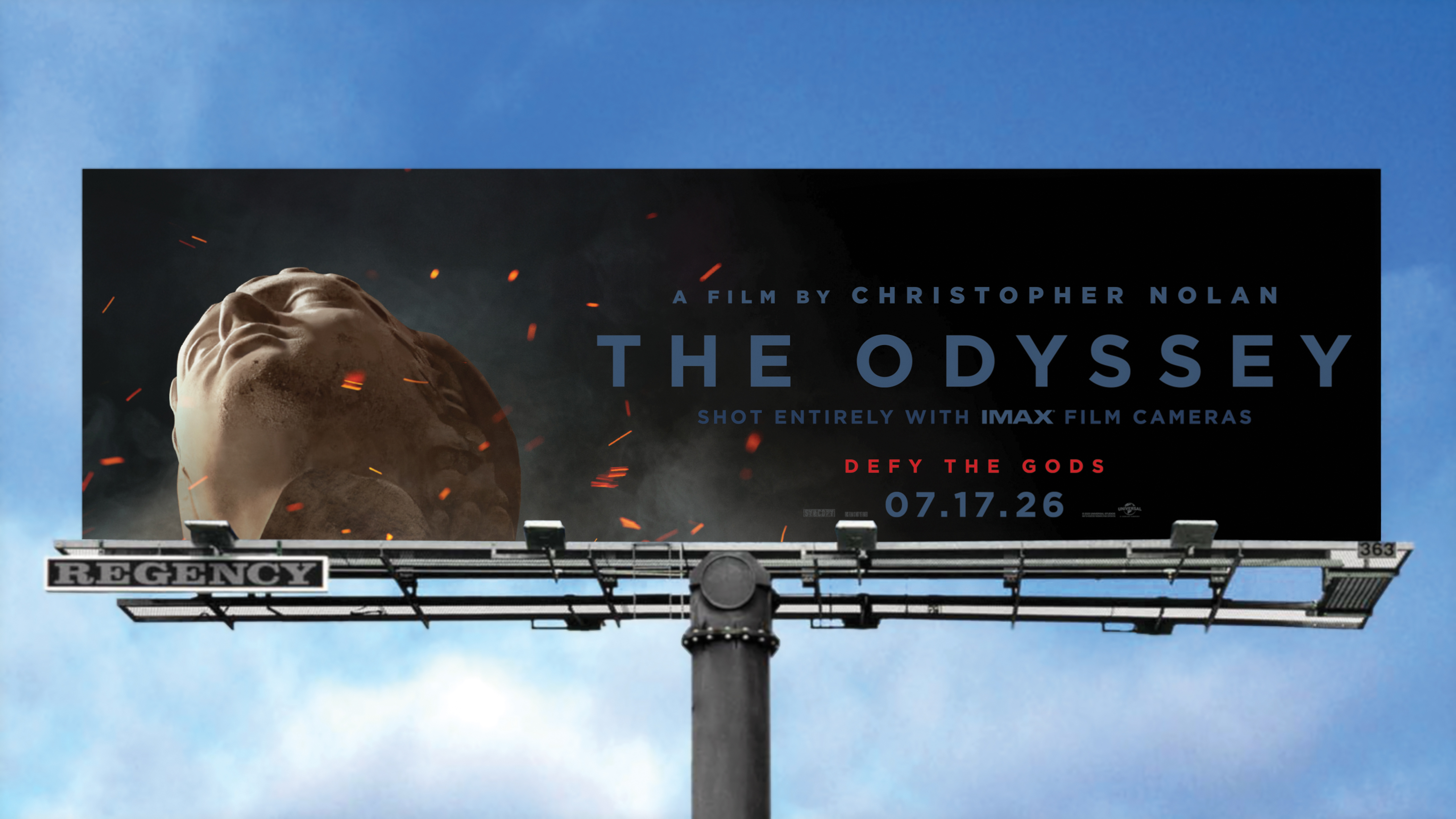 Billboard for Christopher Nolan's film The Odyssey featuring a large ancient statue head with sparks and the release date 07.17.26.