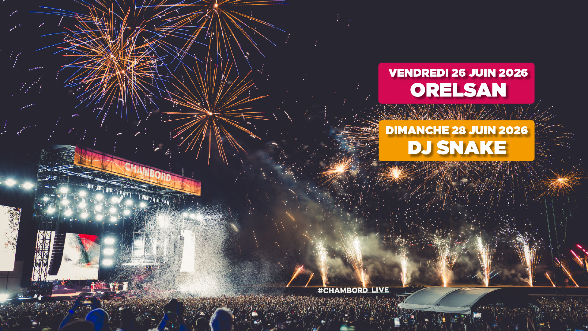 Nighttime concert crowd watching a brightly lit stage with fireworks exploding overhead and names of performers Orelsan and DJ Snake displayed.