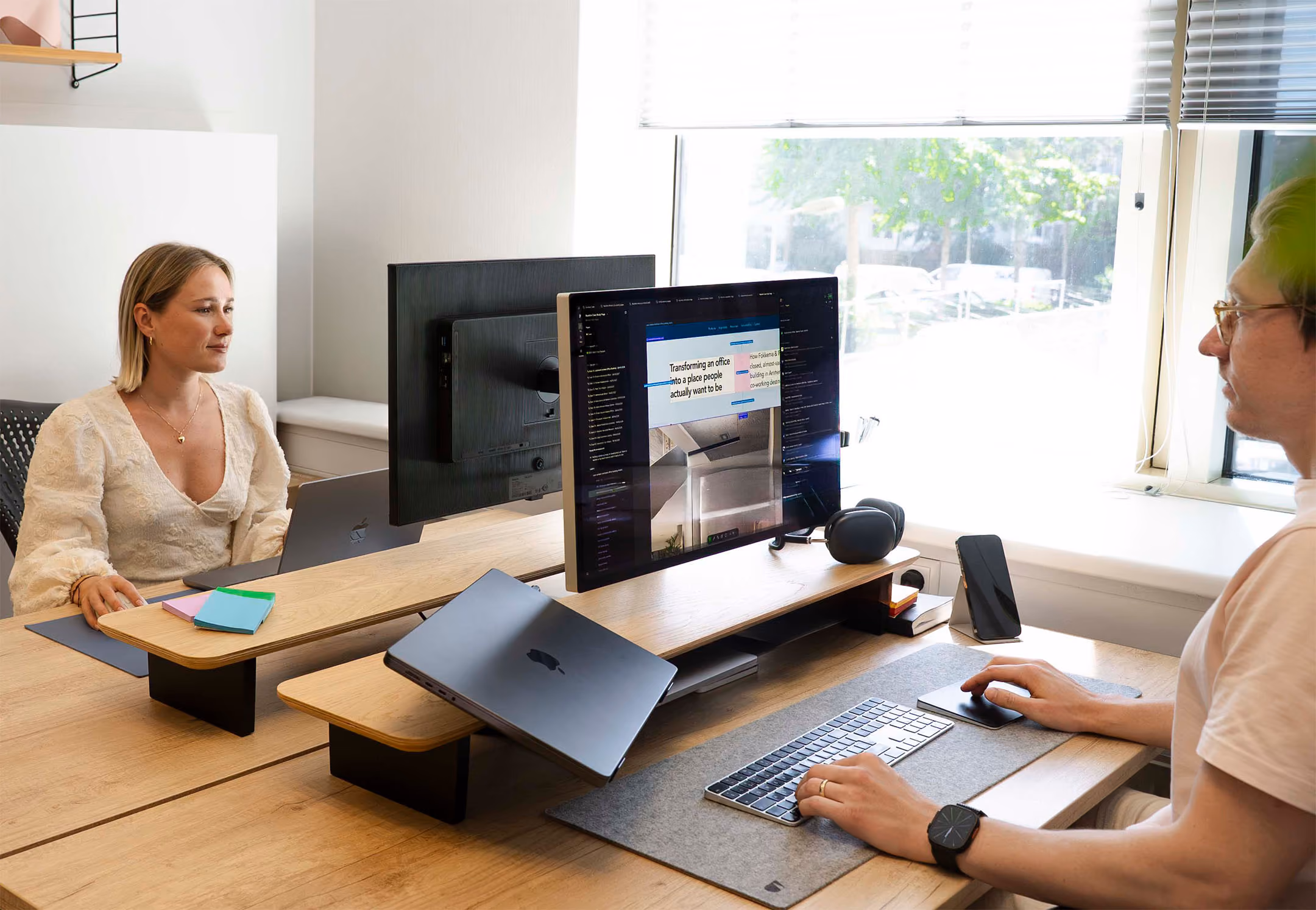 Team members working on design project's behind their monitors in a well lit modern office.