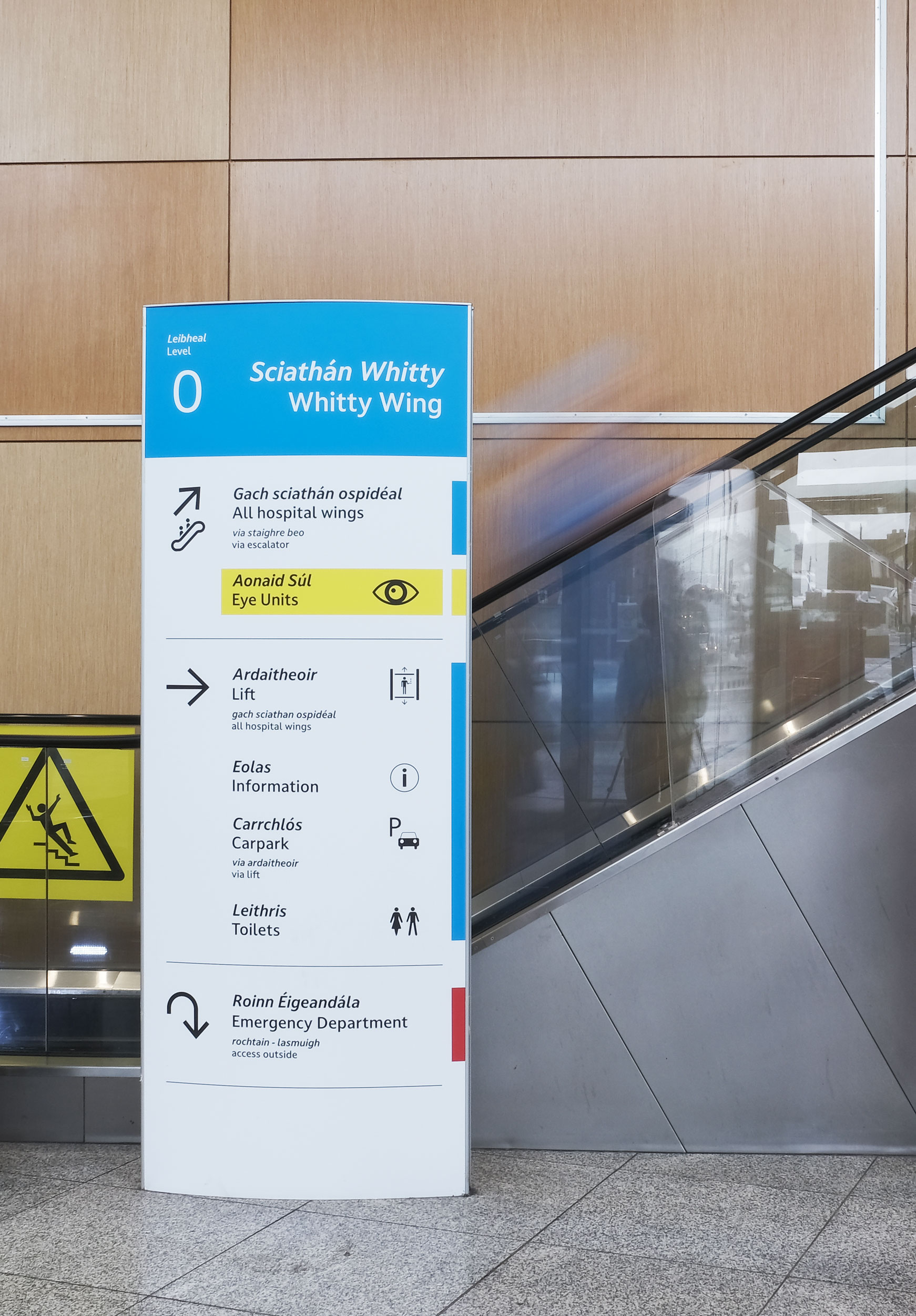 People walking past new signage for the Eye Department