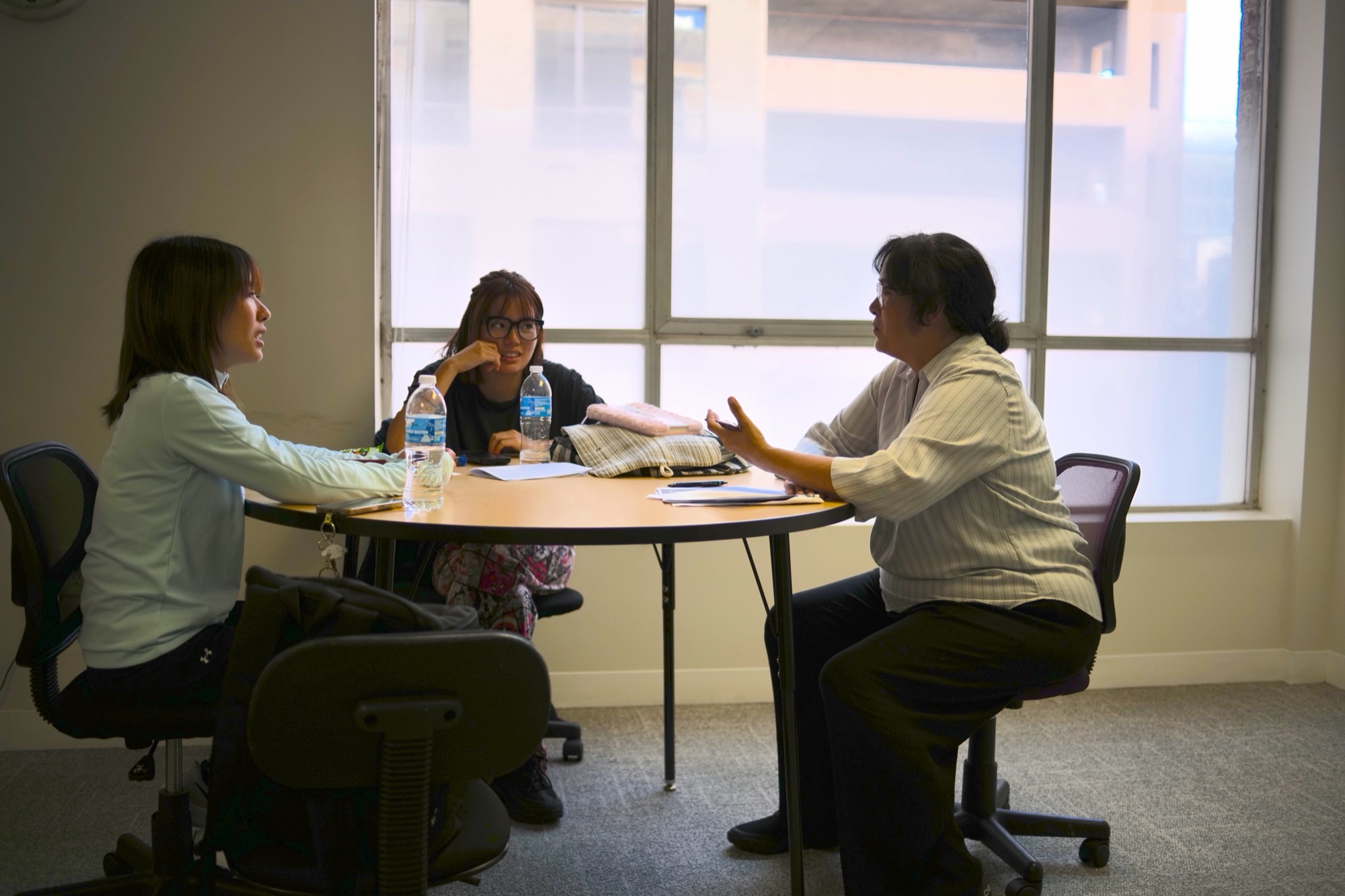 CWC students practicing English speaking with a teacher in class