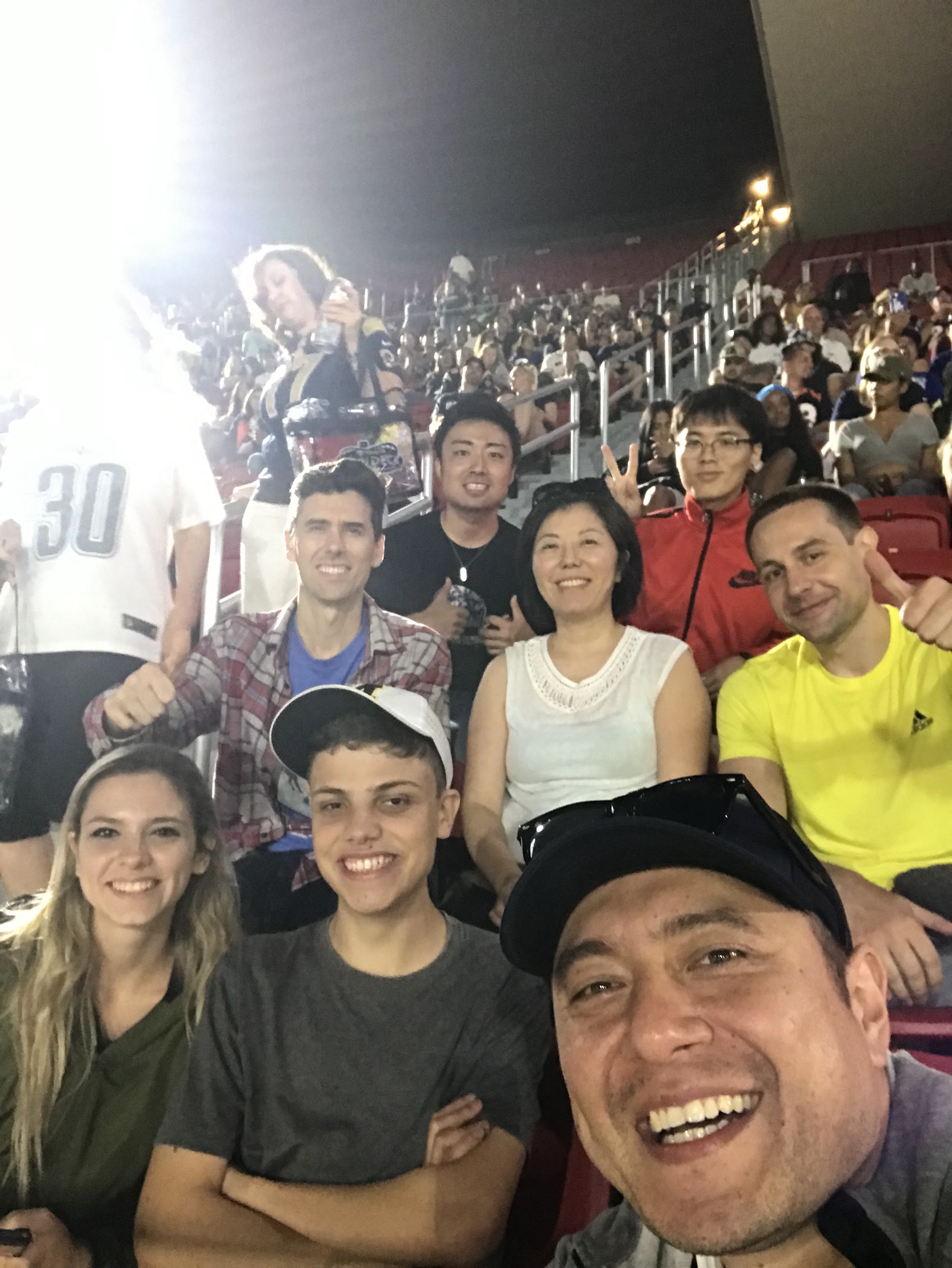 CWC students taking a group selfie at a stadium sports game on a Columbia West College social outing