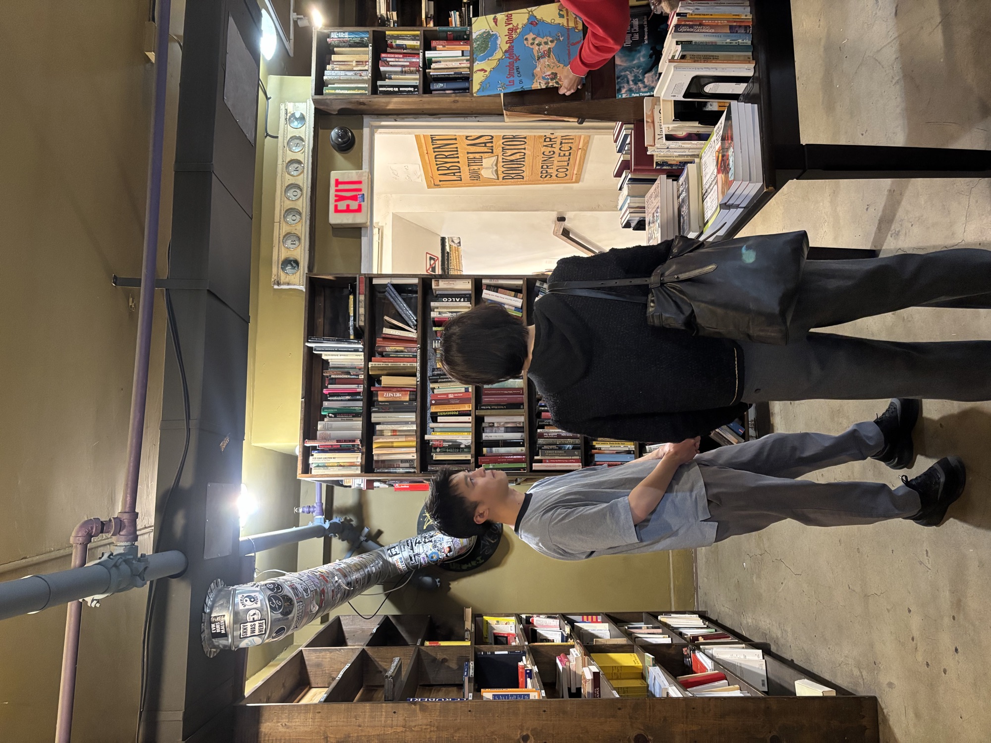 Two Columbia West College students posing by the Labyrinth sign at The Last Bookstore in downtown LA, exploring English culture outside the classroom