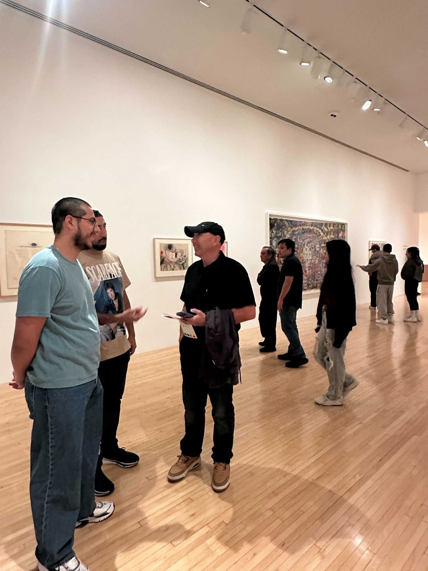 Three CWC students trying an interactive exhibit at MOCA Geffen, illustrating how Columbia West College combines cultural exploration with how to learn English goals