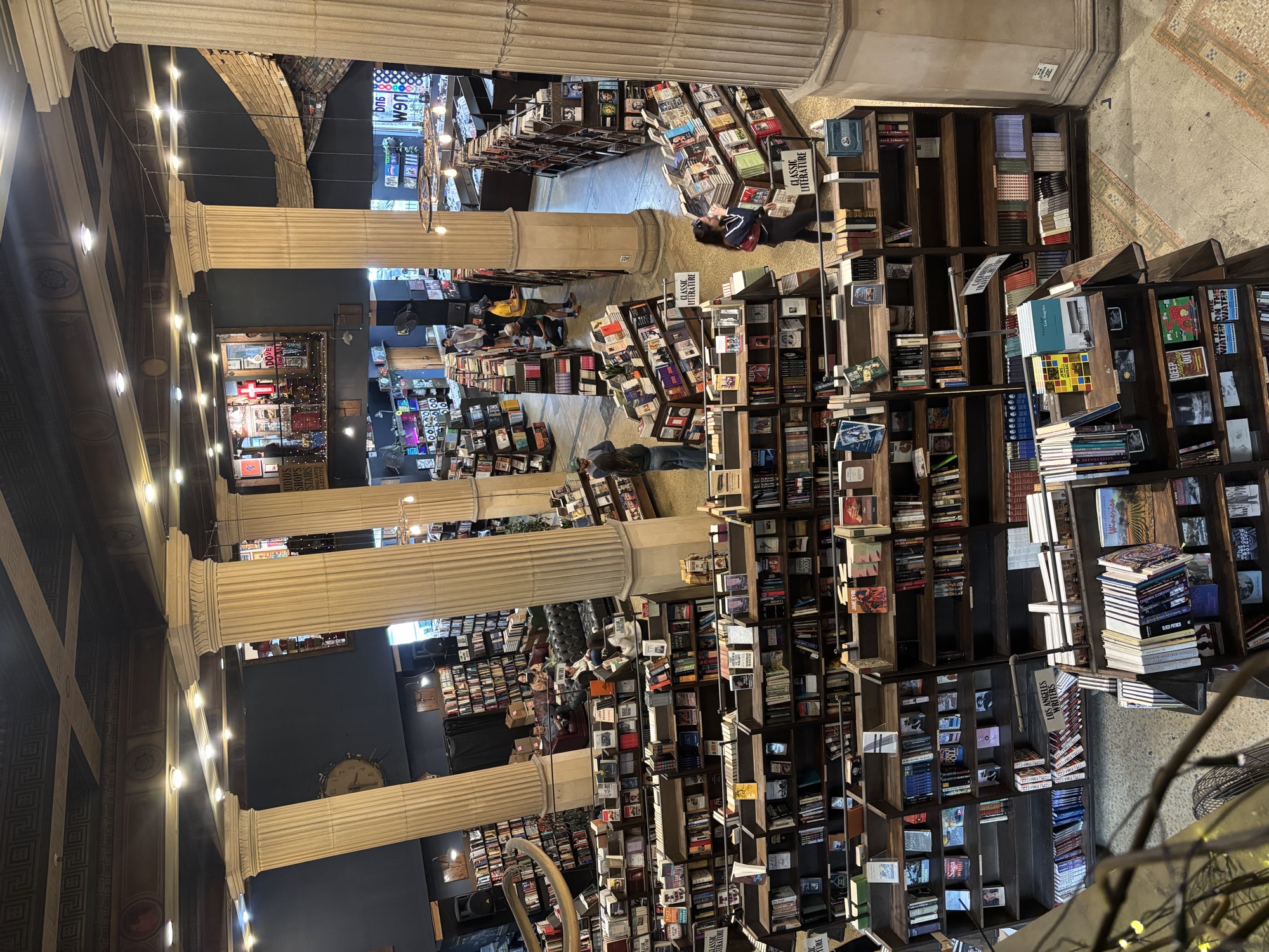 Main floor of The Last Bookstore with columns and string lights, a popular CWC cultural outing destination in Los Angeles