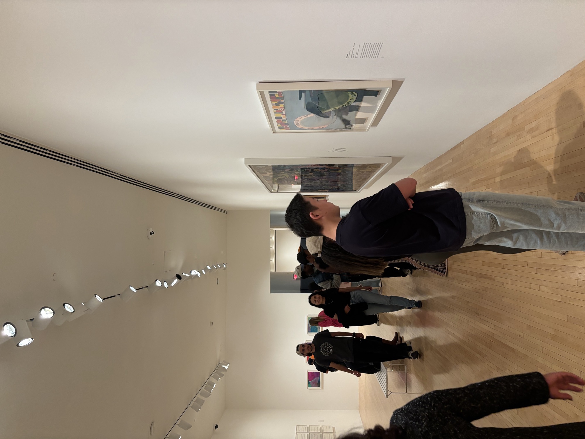 CWC students walking through a hall of colorful paintings at MOCA, developing cultural fluency for business communication