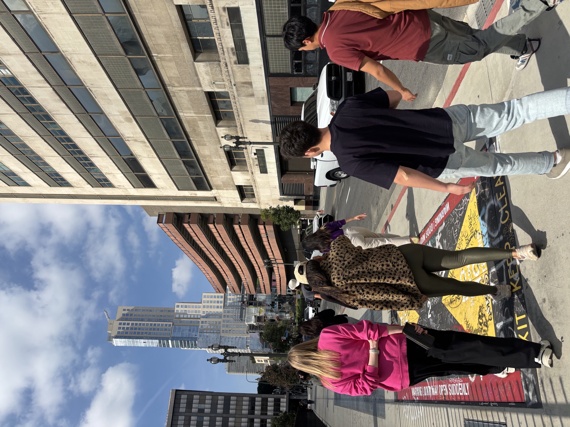 CWC students arriving outside MOCA with the downtown Los Angeles skyline in the background, exploring the world of British slang on a cultural field trip