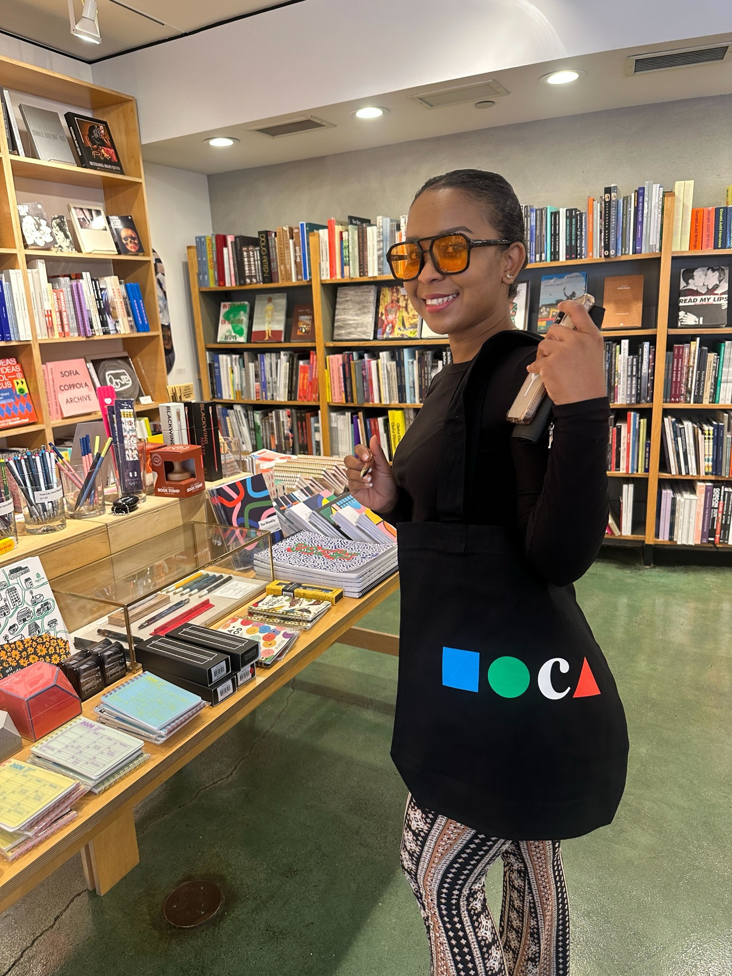 Columbia West College student with a MOCA tote bag by the