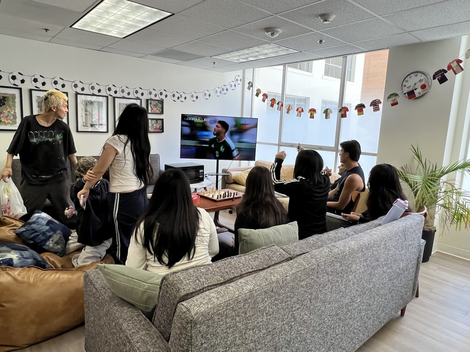 CWC students using English together in the campus lounge, where gerund choices become part of natural conversation