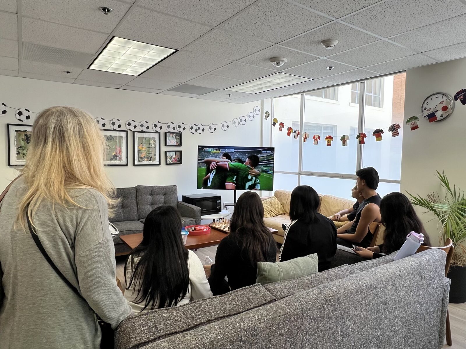 CWC students in a campus lounge, having gathered for an activity, as an example of a completed action before another event