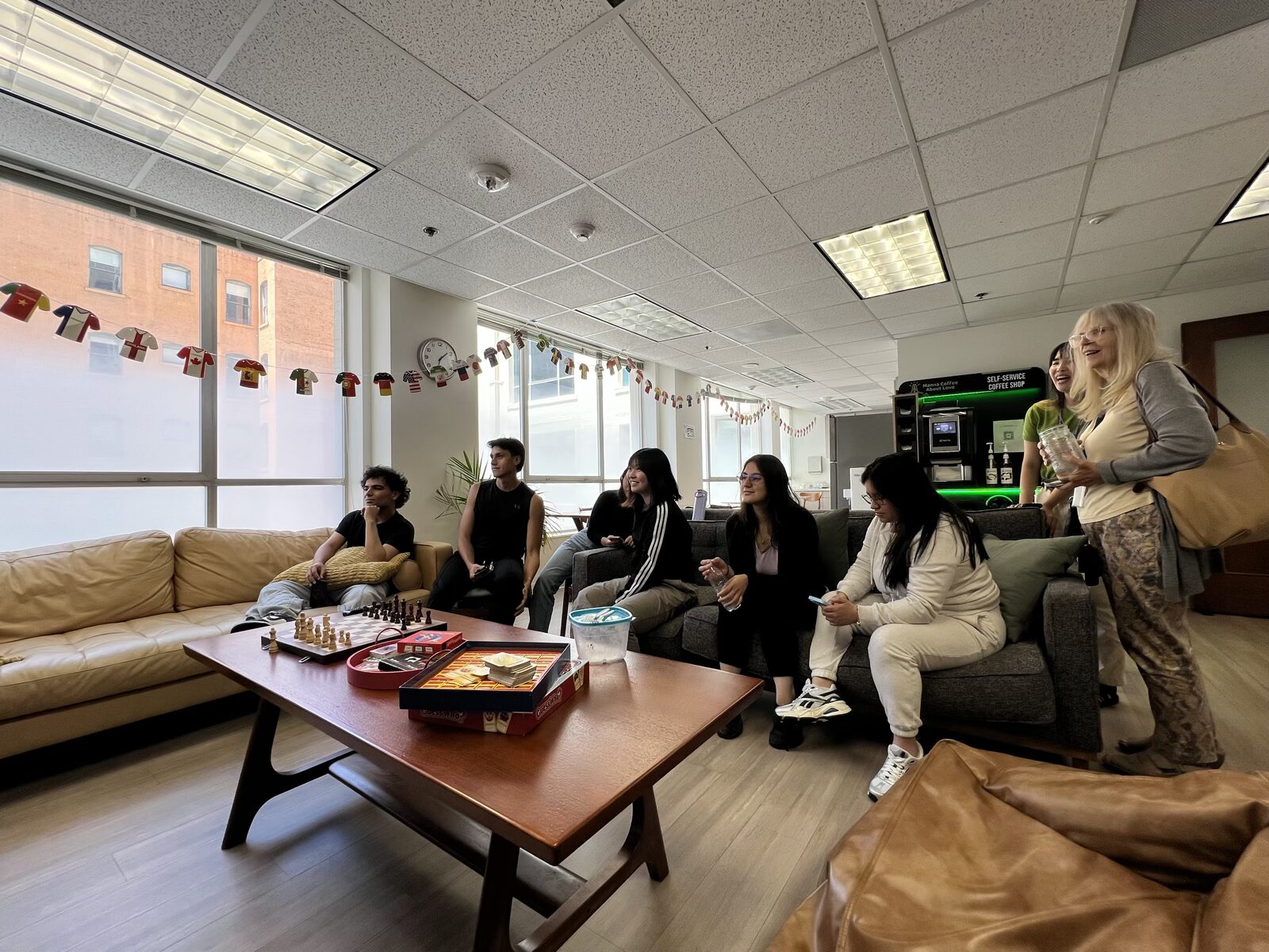 CWC students watching an activity in the campus lounge, a natural setting for everyday phrasal verbs