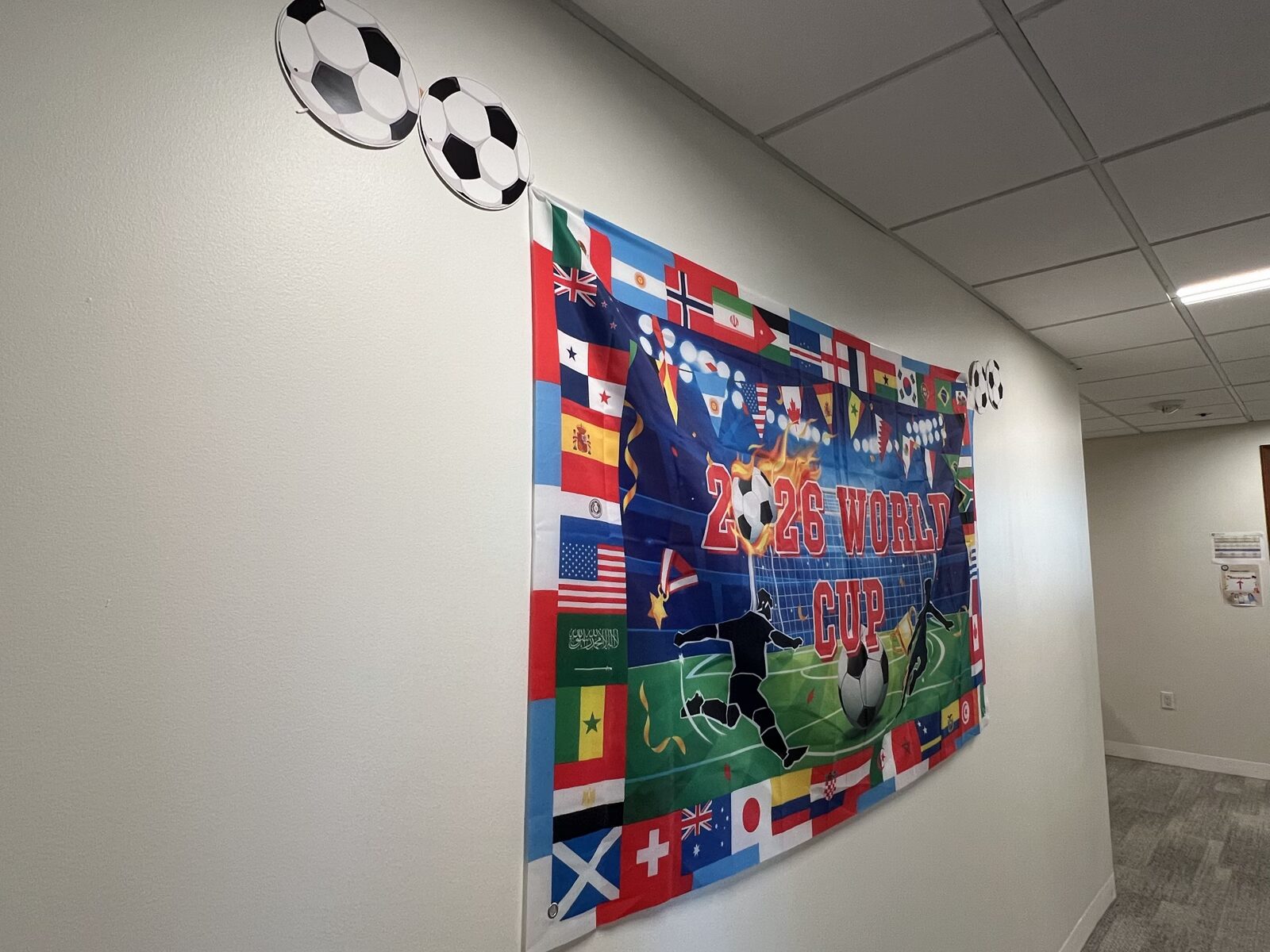 A World Cup hallway banner at CWC representing different possible outcomes from one shared condition