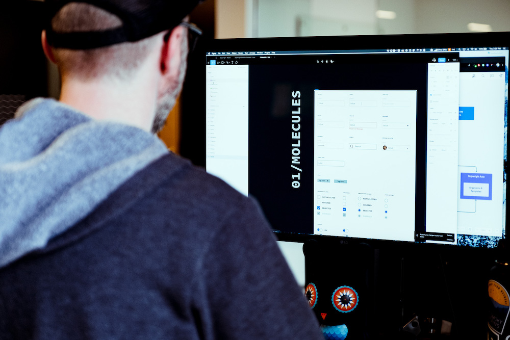product designer at desk working in Figma app