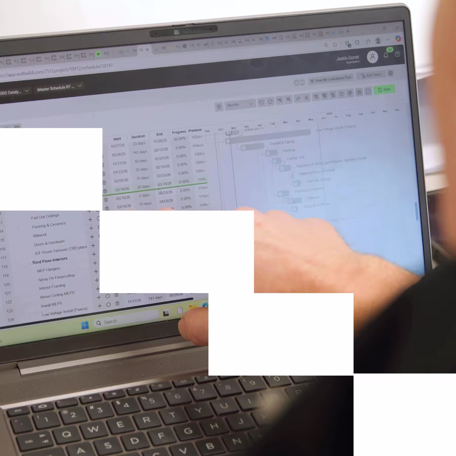 Team of construction professionals walk a jobsite in high visability gear and hard hats.