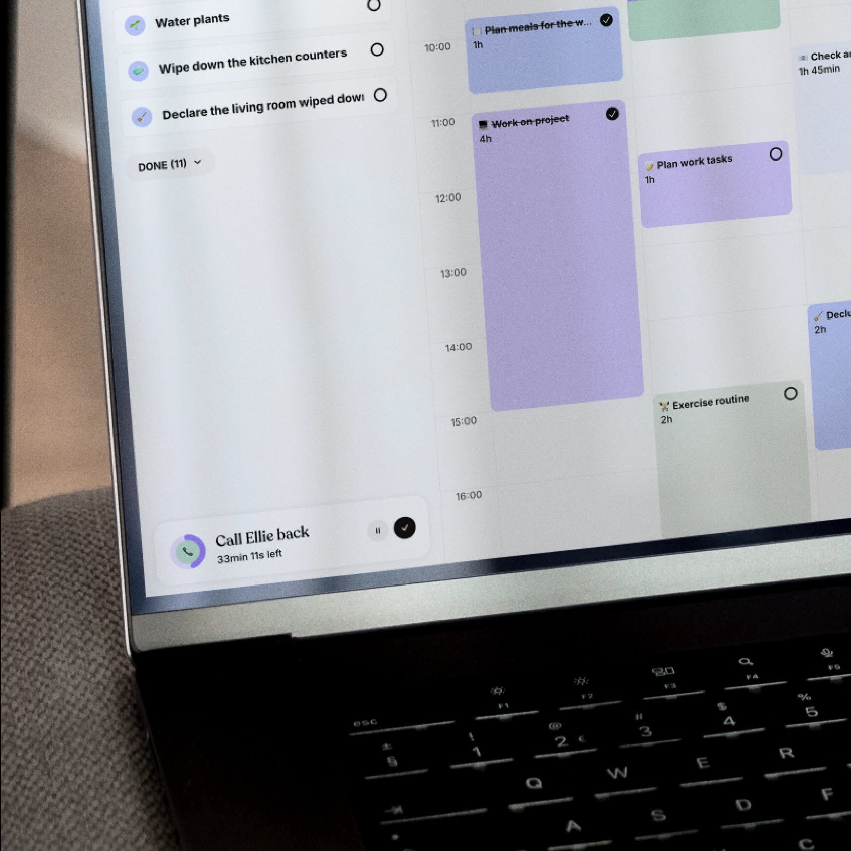 A desktop calendar in the Tiimo app showing a full-day color-coded schedule with tasks like work, exercise, and cleaning.