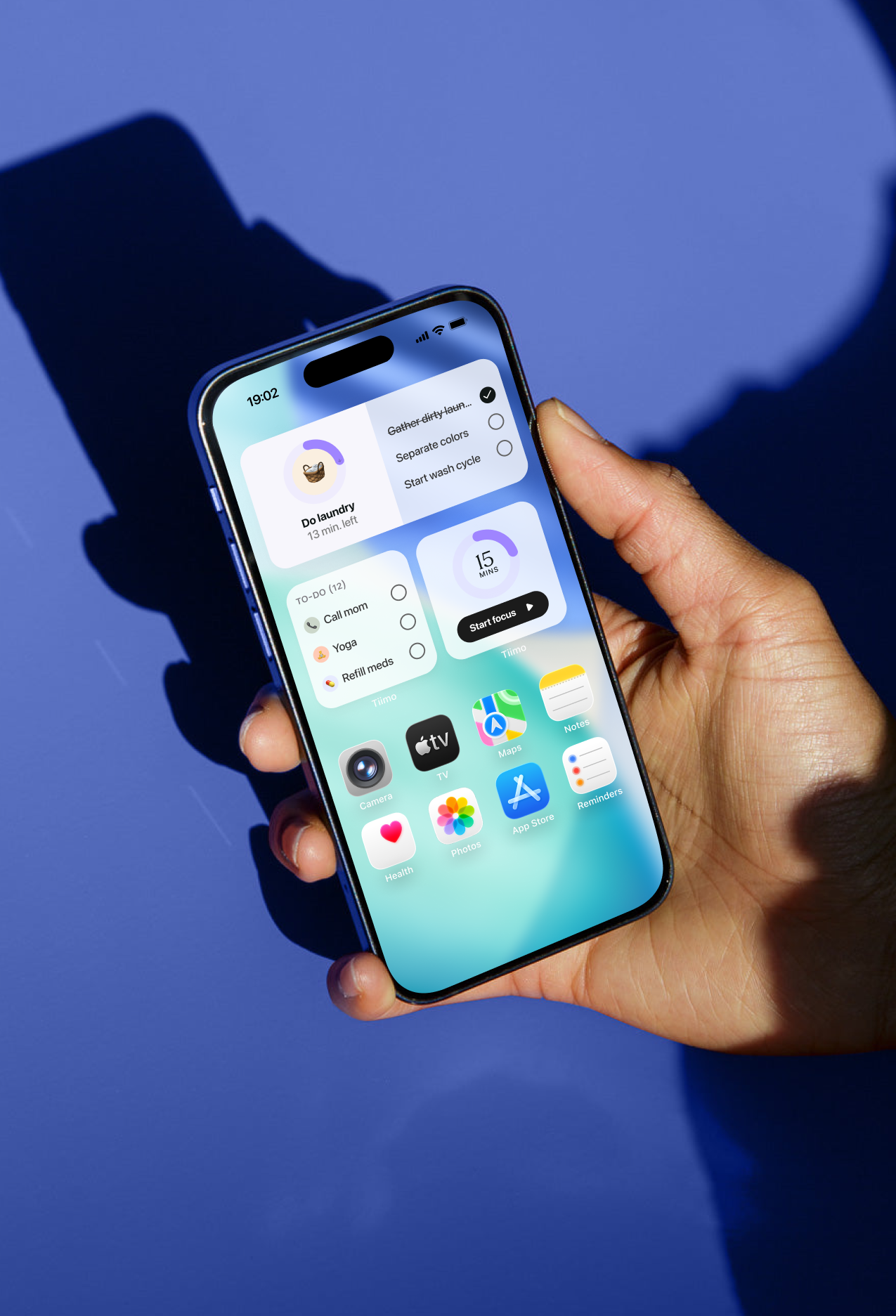 A smartphone shows a Tiimo widget with a timer and tips for staying on task, displayed on the home screen.