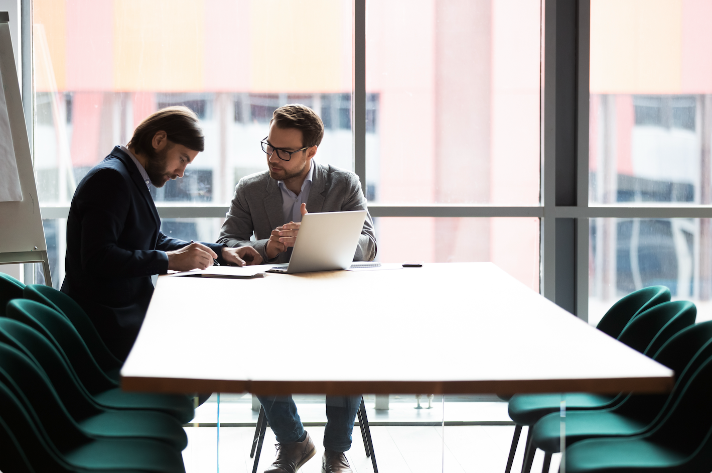 A financial adviser discusses family office services with a wealthy client.