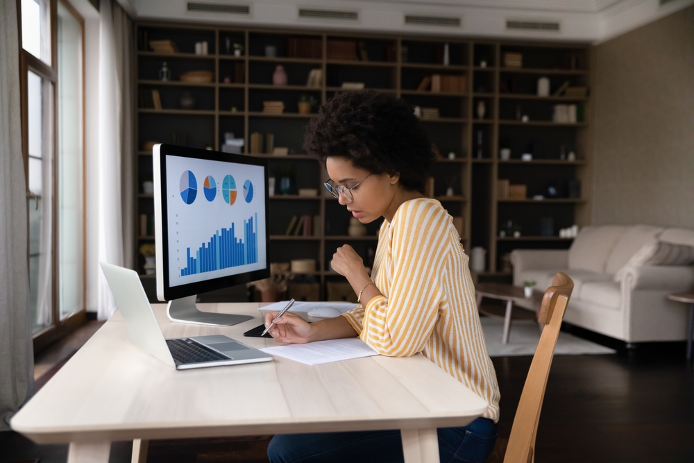woman sitting at computer desks analyzing data