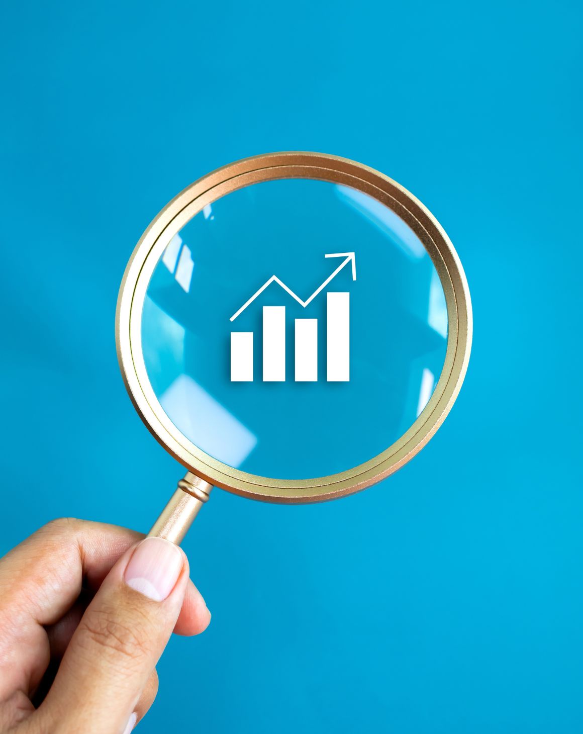 hand holding a microscope looking at a chart