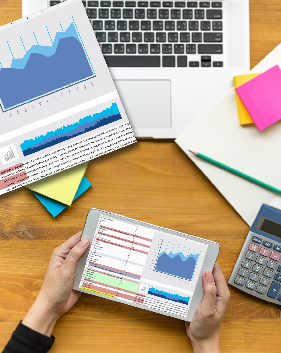 hands holding tablet displaying a data and a graph