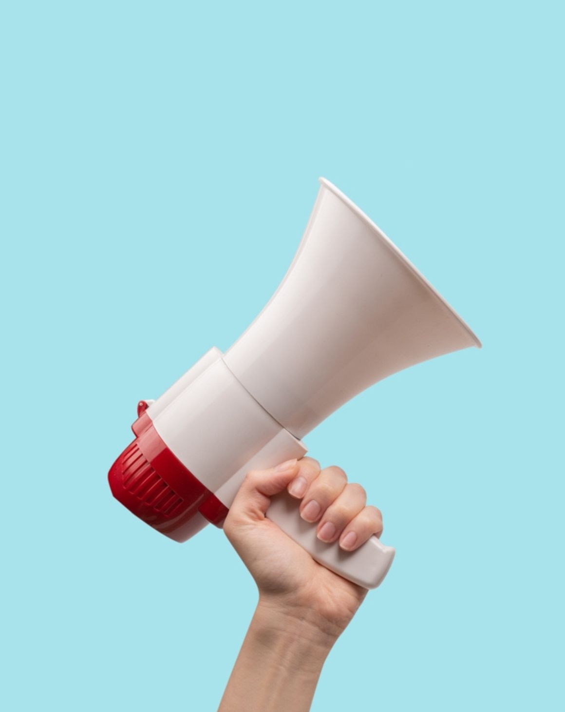 a person holds a megaphone against a blue background