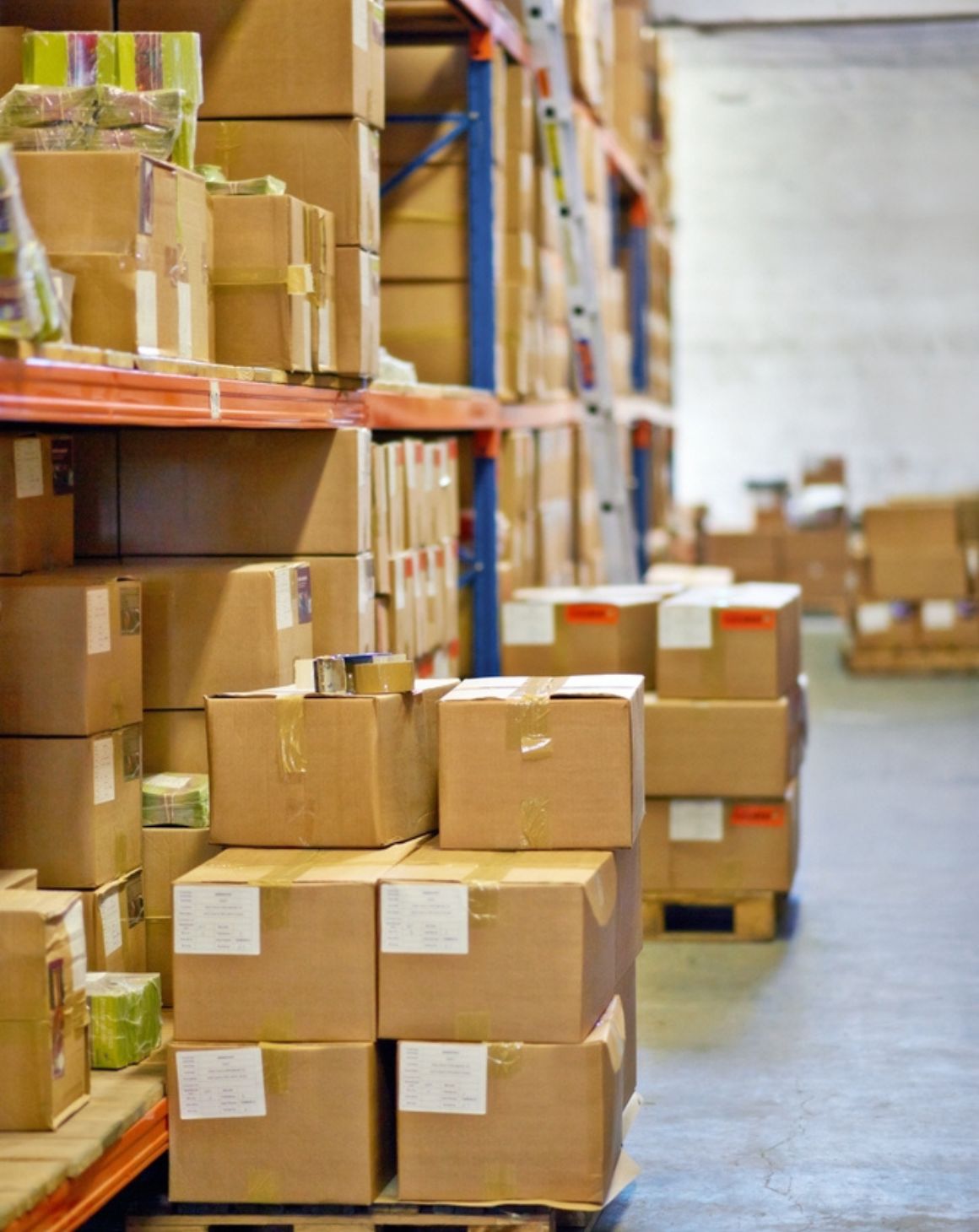 a warehouse filled with stacked boxes and organized shelves