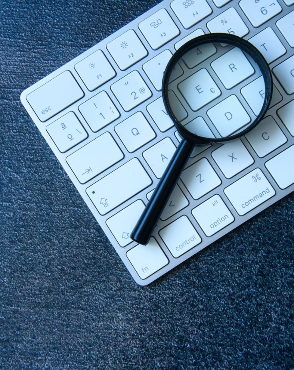 a magnifying glass resting on a keyboard