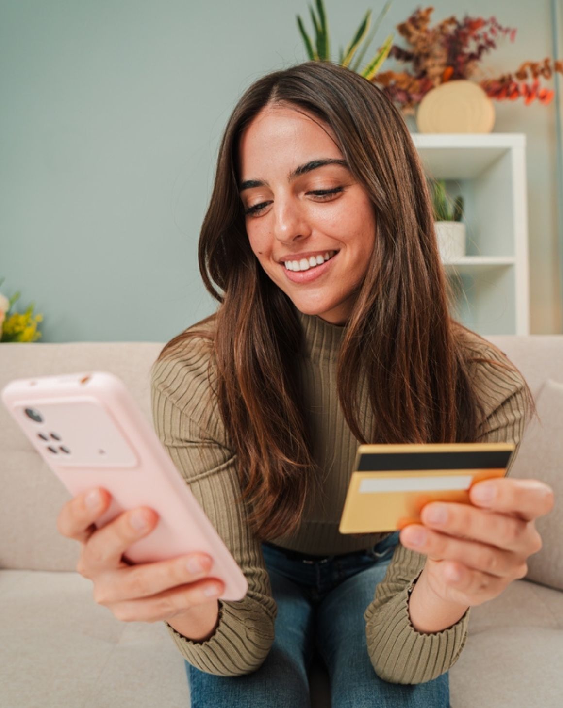 a woman shopping online uses her credit card to check out