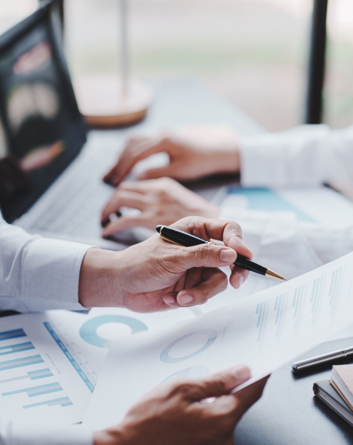 business professionals collaborating on a document at a desk