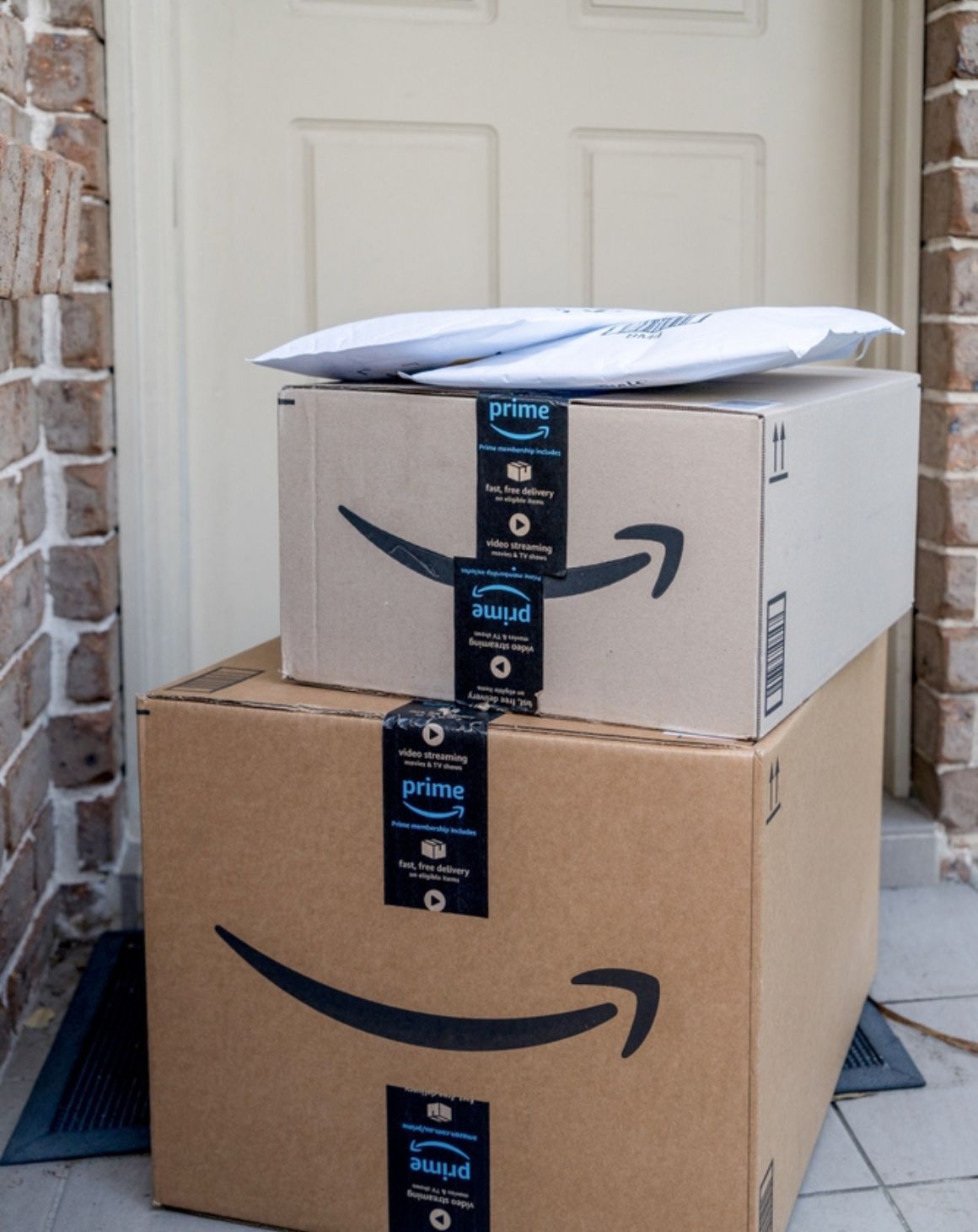 Amazon prime package stacked up in front of a residential home