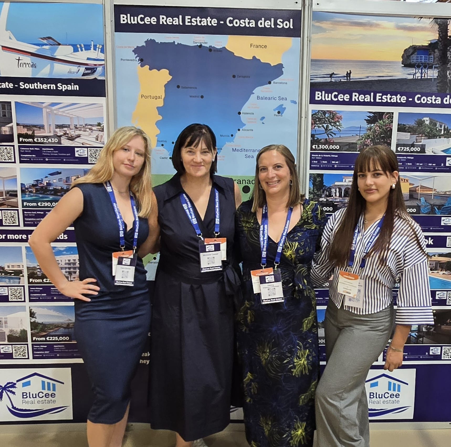 BluCee Real Estate team posing in front of a stand
