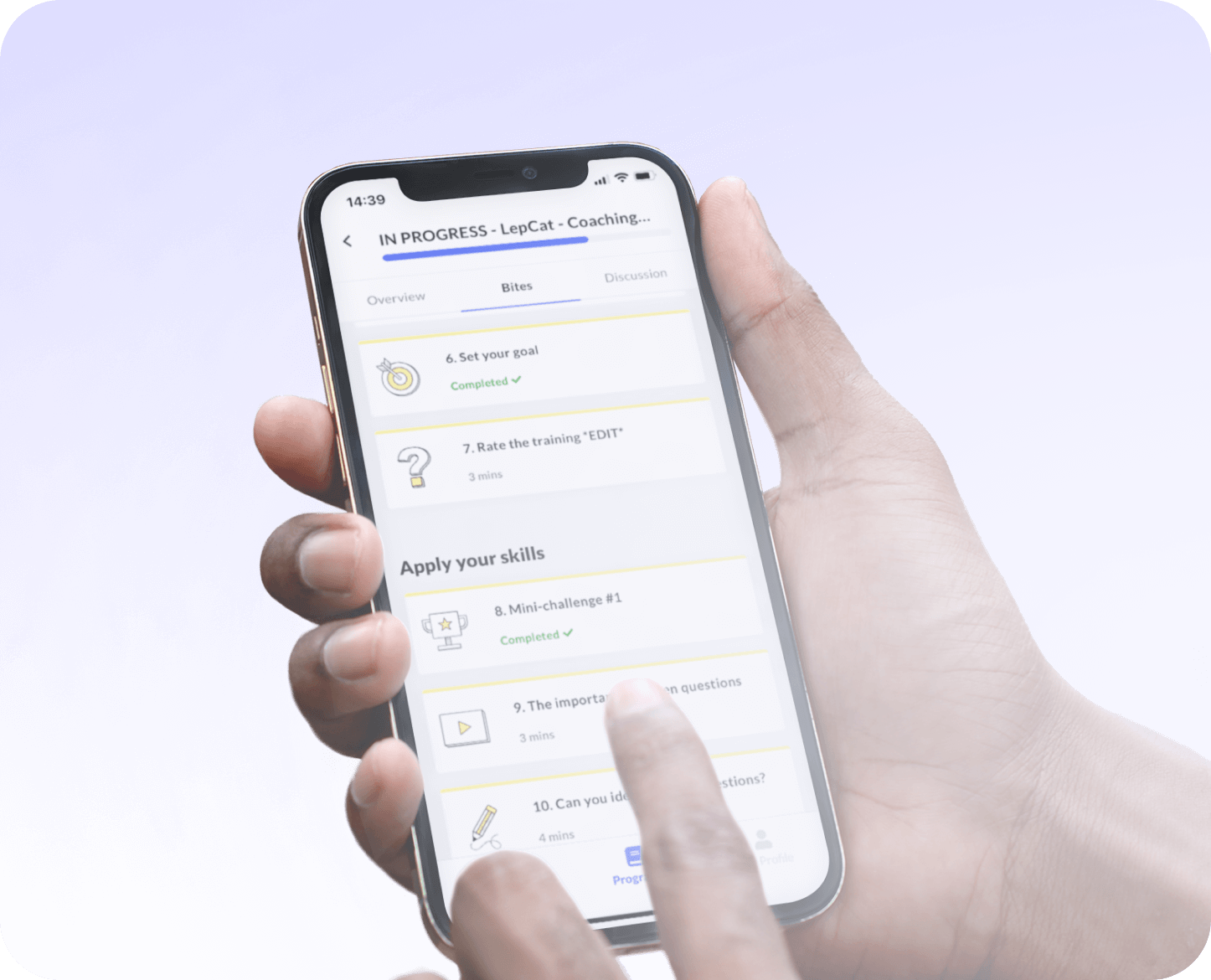Hand holding smartphone displaying a progress screen for a coaching app with sections titled Set your goal, Rate the training, and Apply your skills.