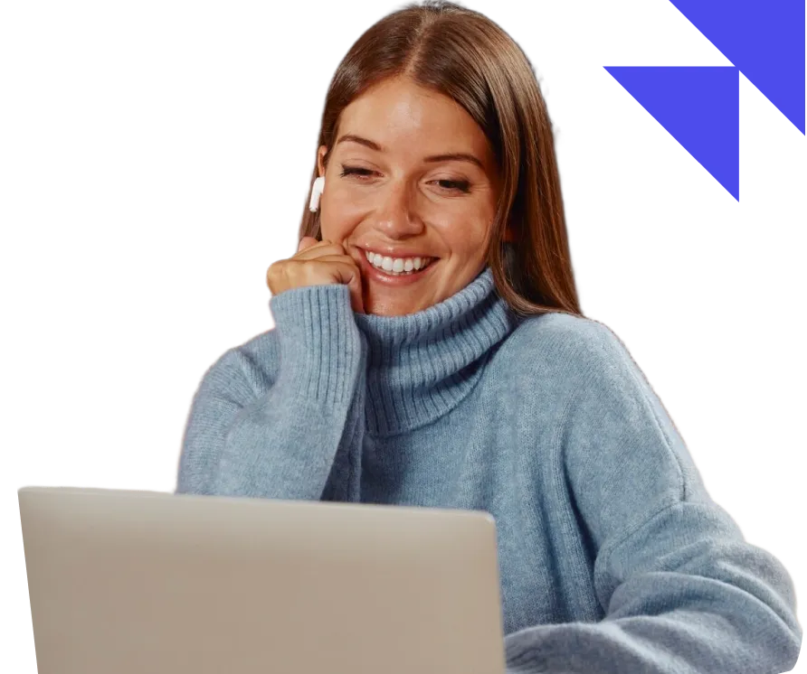 Smiling woman wearing a blue turtleneck sweater and wireless earbuds looking at a laptop screen.