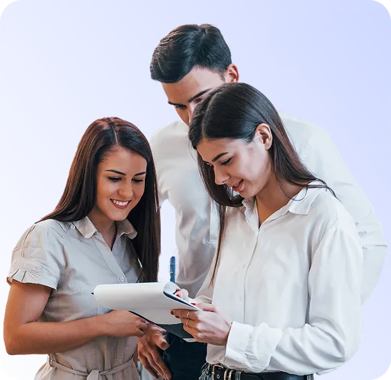 Three young professionals reviewing notes on a clipboard together against a light purple background.