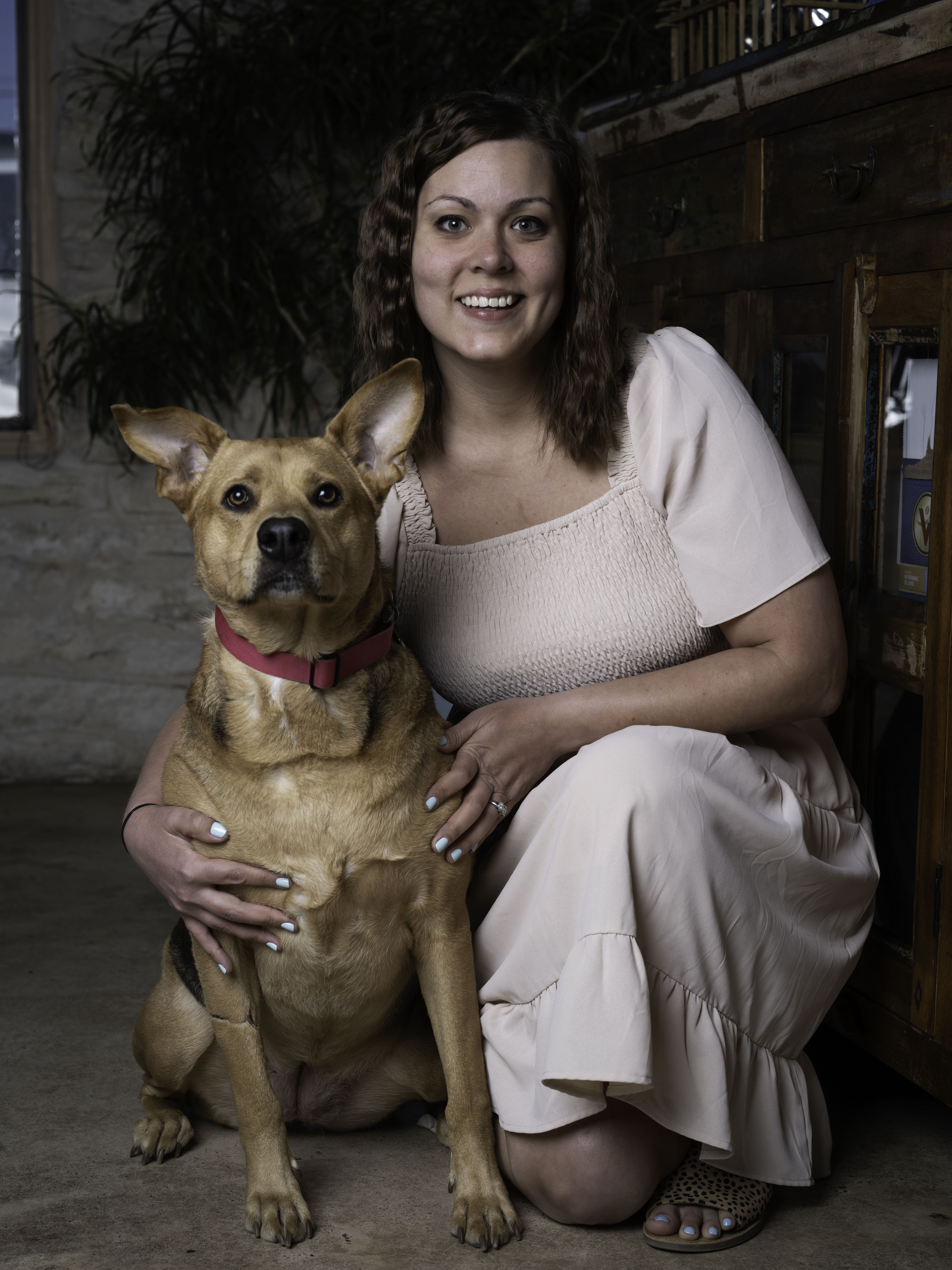 a woman holding a small dog in her arms