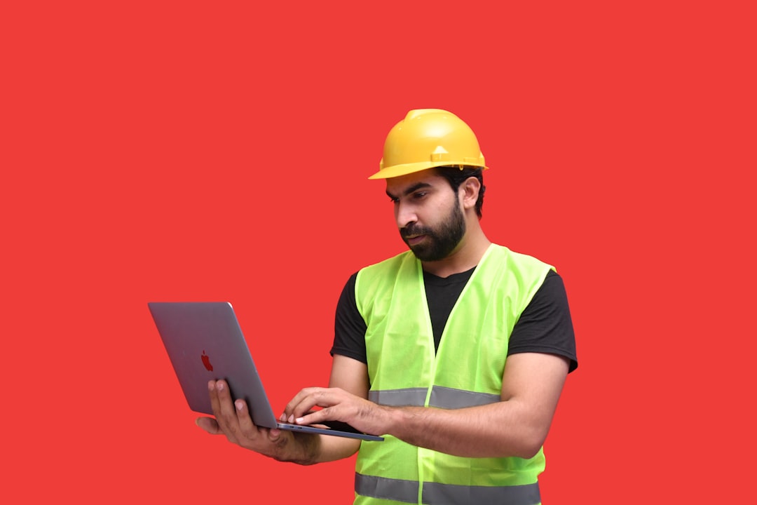 photorealistic image of a contractor using a tablet to manage a project budget - liability insurance for building contractors