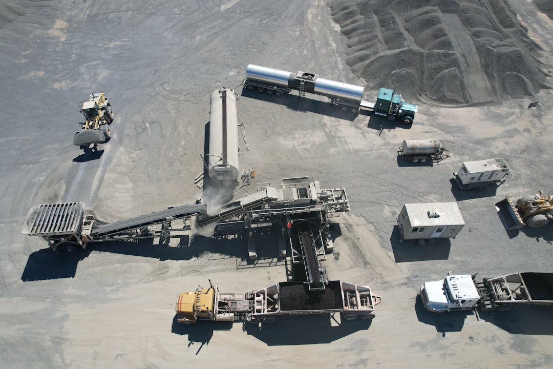 photorealistic image of various construction vehicles and equipment at a job site - liability insurance for building contractors