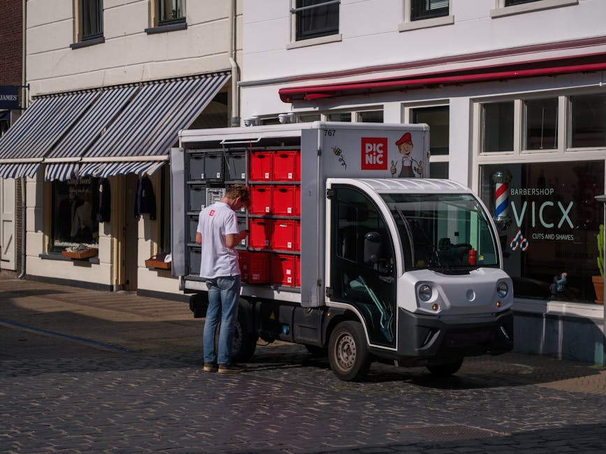 Close-up of a modern EV charging pedestal with blue LED lighting and a digital display - business auto insurance for contractors in maine concept