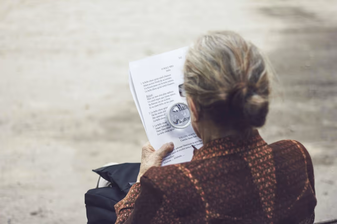 Person thoughtfully reviewing insurance documents - Condo insurance in Massachusetts Person thoughtfully reviewing insurance documents - Condo insurance in Massachusetts