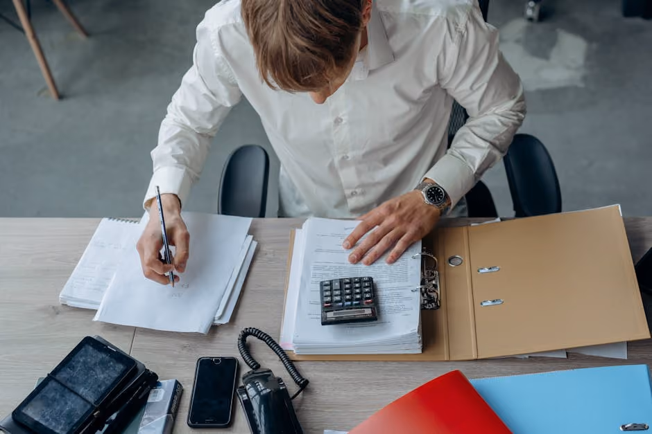 business owner reviewing budget and insurance documents - business liability insurance coverage