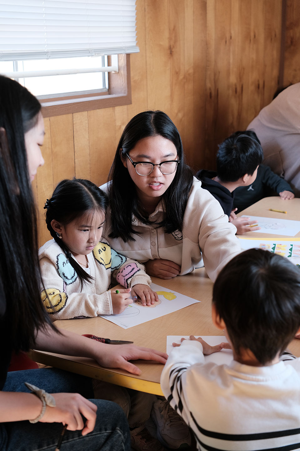 Woman teaching toddler at school