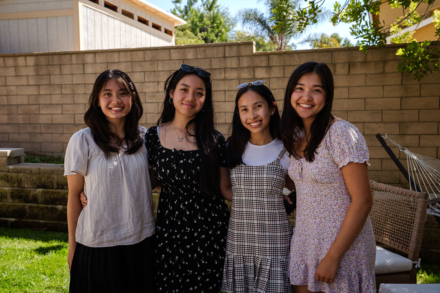 Four girls outside taking a picture in backyard